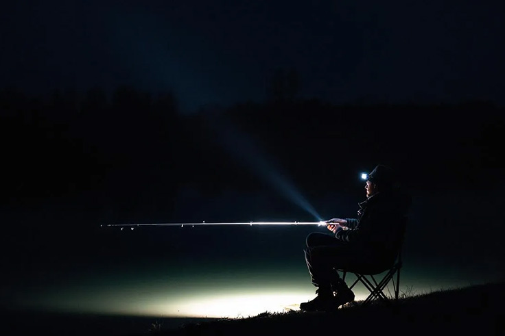 Man sitting in the dark night fishing